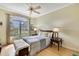 Bedroom with wood floors, large window, and stylish furnishings at 10093 Holly Berry Dr, Weeki Wachee, FL 34613
