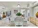 Bright dining area featuring a glass table, wicker chairs, and views into the adjacent living area at 10093 Holly Berry Dr, Weeki Wachee, FL 34613