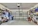 Spacious two car garage with ample storage, shelving, and accessories on either side at 10093 Holly Berry Dr, Weeki Wachee, FL 34613
