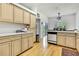 Well-lit kitchen with wood floors, light cabinets, and modern appliances, offering both style and functionality at 10093 Holly Berry Dr, Weeki Wachee, FL 34613