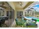 Outdoor patio with sliding glass doors, ceiling fan, grill and a view of the swimming pool at 10093 Holly Berry Dr, Weeki Wachee, FL 34613