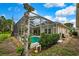 The pool sits within a screened enclosure with a view of the house and the surrounding yard at 10093 Holly Berry Dr, Weeki Wachee, FL 34613