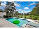 Inviting screened in swimming pool with an inflatable toy and outdoor furniture at 10093 Holly Berry Dr, Weeki Wachee, FL 34613