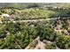 An aerial shot features houses and wooded acreage, with power lines clearly visible at 10149 Rockbay Rd, Brooksville, FL 34601