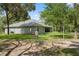 Spacious backyard surrounds the home with a well and partially covered outdoor patio at 10149 Rockbay Rd, Brooksville, FL 34601
