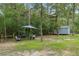 A beautiful backyard setup for grilling, featuring outdoor seating and a shed tucked among the trees at 10149 Rockbay Rd, Brooksville, FL 34601