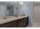 This bathroom features a dual sink vanity, modern finishes, and a glass enclosed shower at 10149 Rockbay Rd, Brooksville, FL 34601
