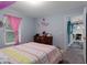 This bedroom boasts soft carpet, stylish decor, and a sunny window at 10149 Rockbay Rd, Brooksville, FL 34601