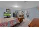 This bedroom features soft carpet, a TV, and access to both a walk-in closet and ensuite bathroom at 10149 Rockbay Rd, Brooksville, FL 34601