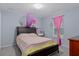 A cozy bedroom featuring soft carpet, a queen sized bed, and stylish decor at 10149 Rockbay Rd, Brooksville, FL 34601
