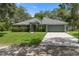 Lovely single-story home featuring a well-manicured lawn and a driveway leading to an attached two-car garage at 10149 Rockbay Rd, Brooksville, FL 34601