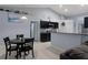 Modern kitchen with dark cabinetry, granite countertops, and stainless steel appliances at 10149 Rockbay Rd, Brooksville, FL 34601