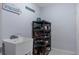 Convenient laundry room has a utility sink and shoe rack for organization with decor that reads 'Sunbathing' at 10149 Rockbay Rd, Brooksville, FL 34601