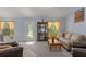 Cozy living room featuring comfortable seating, a display cabinet, and a bright atmosphere at 10149 Rockbay Rd, Brooksville, FL 34601
