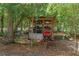 A rustic outbuilding is secured behind a chainlink fence at 10149 Rockbay Rd, Brooksville, FL 34601
