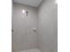A modern walk-in shower with seamless glass and elegant white tile at 10149 Rockbay Rd, Brooksville, FL 34601
