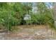 Rustic treehouse surrounded by lush greenery, offering a unique play space for children at 10149 Rockbay Rd, Brooksville, FL 34601