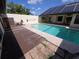 Backyard featuring a pool and solar panels on the roof, providing energy efficiency at 10244 Hoover St, Spring Hill, FL 34608