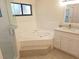 Relaxing bathroom with a large soaking tub, separate shower, and modern fixtures at 10244 Hoover St, Spring Hill, FL 34608