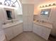 Elegant bathroom with dual sinks, quartz countertops, and stylish cabinetry at 10244 Hoover St, Spring Hill, FL 34608