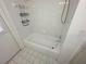 All white tiled shower and tub with shower head at 10244 Hoover St, Spring Hill, FL 34608