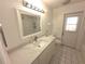 Bathroom with white vanity, quartz countertop and tile flooring at 10244 Hoover St, Spring Hill, FL 34608