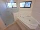Modern bathroom featuring a glass-enclosed shower and luxurious soaking tub at 10244 Hoover St, Spring Hill, FL 34608