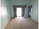 Bright bedroom featuring a sliding glass door and neutral carpeting at 10244 Hoover St, Spring Hill, FL 34608