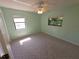 Comfortable bedroom bathed in natural light from two windows and carpet at 10244 Hoover St, Spring Hill, FL 34608