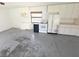 Open bonus room with kitchen components and painted concrete floor at 10244 Hoover St, Spring Hill, FL 34608