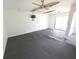 Bonus room with ceiling fan, concrete flooring, and sliding glass doors at 10244 Hoover St, Spring Hill, FL 34608