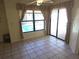 A sunny breakfast nook with tile floors, windows and door overlooking the pool area at 10244 Hoover St, Spring Hill, FL 34608