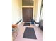 A close up of the entryway showing a double door design, tile flooring, and covered space at 10244 Hoover St, Spring Hill, FL 34608