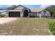Well-maintained single-story home with a two-car garage and drought resistant landscaping at 10244 Hoover St, Spring Hill, FL 34608
