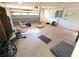 Spacious garage featuring a ceiling fan and garage door at 10244 Hoover St, Spring Hill, FL 34608