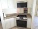 Modern kitchen with stainless steel appliances, granite countertops, and ample cabinet space at 10244 Hoover St, Spring Hill, FL 34608