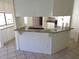 A partial view of kitchen featuring an island with granite countertop at 10244 Hoover St, Spring Hill, FL 34608