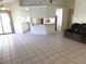 Spacious open-concept living area with tile flooring, connecting seamlessly to the kitchen at 10244 Hoover St, Spring Hill, FL 34608