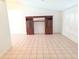 Spacious living room features tile flooring and a large entertainment center at 10244 Hoover St, Spring Hill, FL 34608