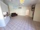 Expansive living room with tile flooring and open layout to the kitchen at 10244 Hoover St, Spring Hill, FL 34608
