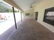 Covered patio with a ceiling fan offering a relaxing outdoor space next to the pool at 10244 Hoover St, Spring Hill, FL 34608