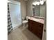 Bathroom featuring a tiled shower, vanity with stone countertop, and neutral color palette at 10301 Ravines Dr, New Port Richey, FL 34654