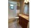 Cozy bathroom with a shower-tub combination and wooden vanity with granite countertop at 10301 Ravines Dr, New Port Richey, FL 34654
