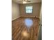 Bedroom with laminate flooring, a window providing natural light, and a neutral color scheme at 10301 Ravines Dr, New Port Richey, FL 34654