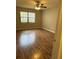 Bedroom with laminate flooring, a window, and a ceiling fan with natural light at 10301 Ravines Dr, New Port Richey, FL 34654
