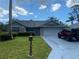 Single-story home with stone accents, and a well-manicured lawn, including an old-style letter box at 10301 Ravines Dr, New Port Richey, FL 34654