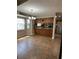 Eat-in kitchen featuring wooden cabinets, tile flooring, and a window overlooking the yard at 10301 Ravines Dr, New Port Richey, FL 34654
