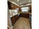Well-equipped kitchen with granite countertops, wood cabinetry, and stainless steel appliances at 10301 Ravines Dr, New Port Richey, FL 34654