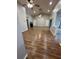 Spacious living room featuring vaulted ceilings, laminate flooring, and a sliding glass door at 10301 Ravines Dr, New Port Richey, FL 34654