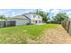Spacious backyard offering ample green space, and a wood fence at 10386 Norvell Rd, Spring Hill, FL 34608